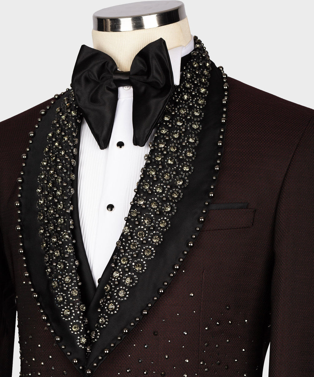 Burgundy tuxedo close-up with black bow tie, jeweled lapel trim, and chest pocket