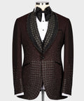 Burgundy tuxedo jacket with round lapels, black satin trim, and gold jeweled pattern