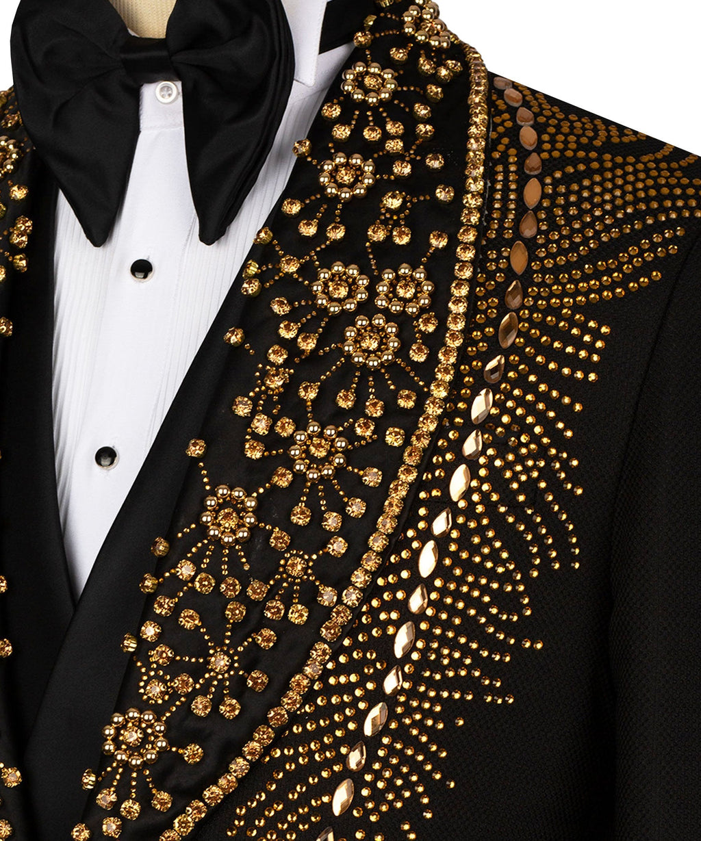 Close-up of black tuxedo lapel with gold stone embroidery over white dress shirt