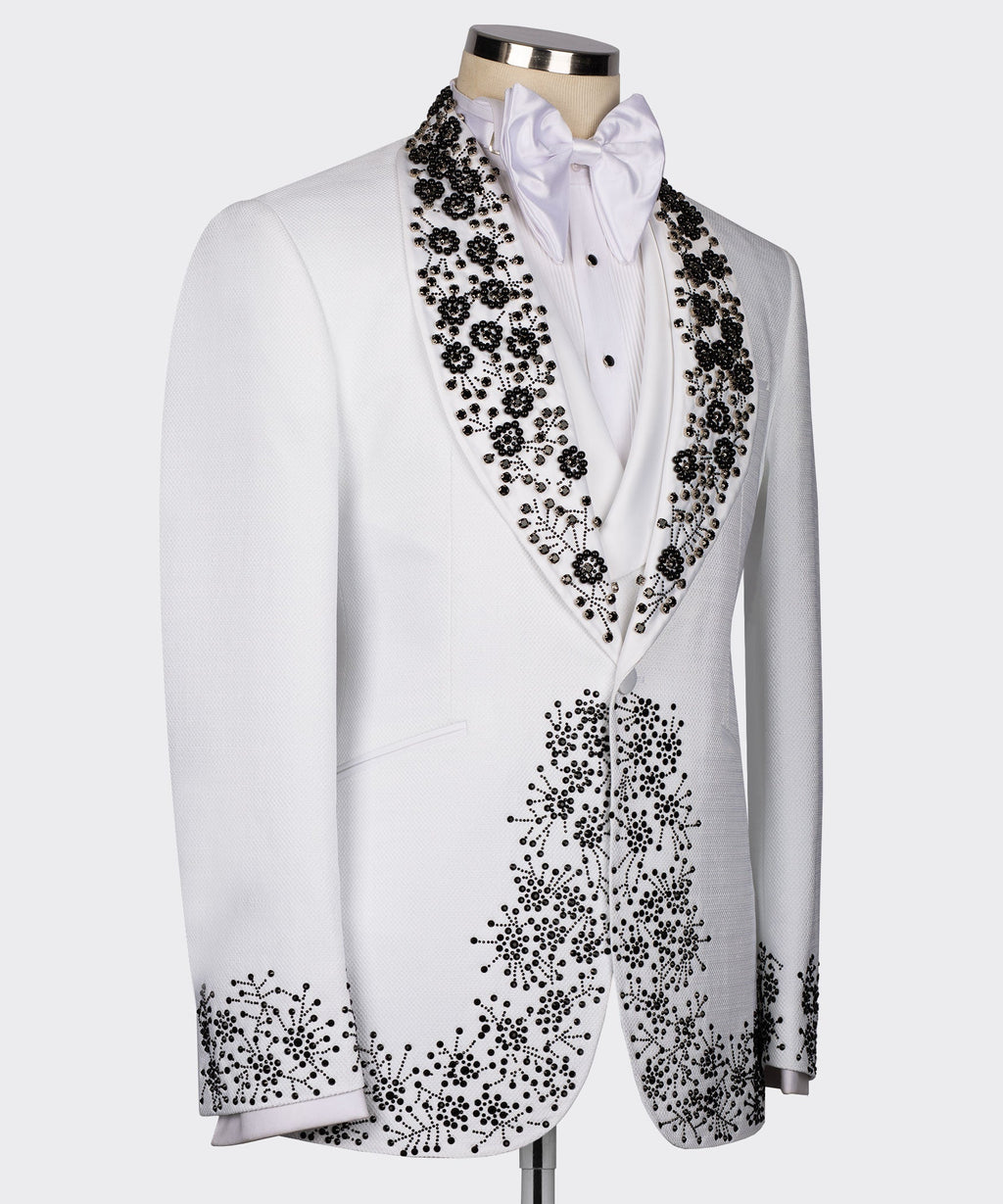 White tuxedo jacket side view with black gemstone embroidery along lapel and cuffs