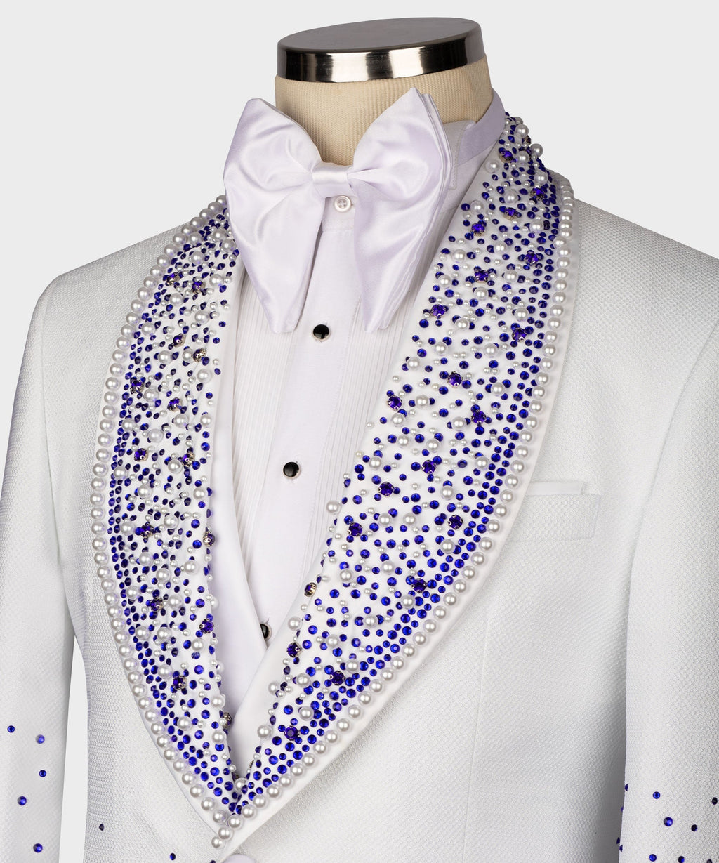 Close-up white tuxedo: blue rhinestone lapels, shirt studs, and bow tie