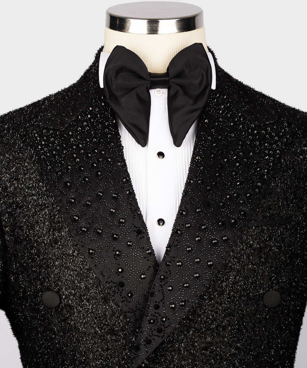 Black tuxedo jacket with bow tie, satin-trim lapels, and sparkling gemstone details
