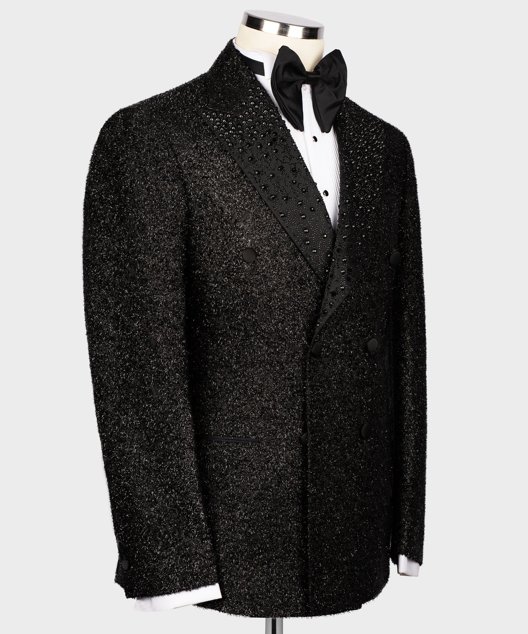 Black tuxedo jacket with bow tie and sparkling gemstone embroidery on the lapels