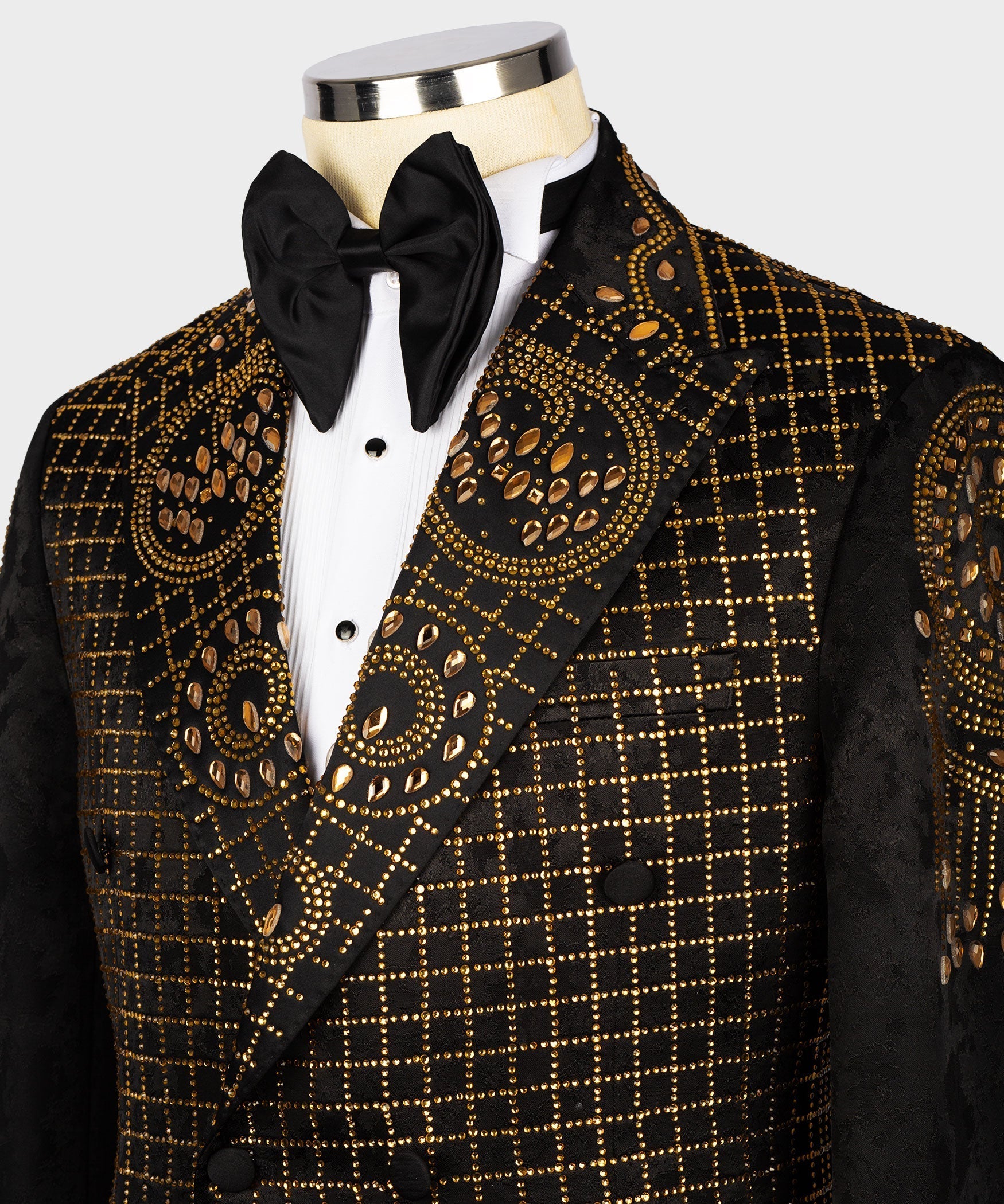 Front close-up: black tuxedo jacket with gold embroidery and black bow tie