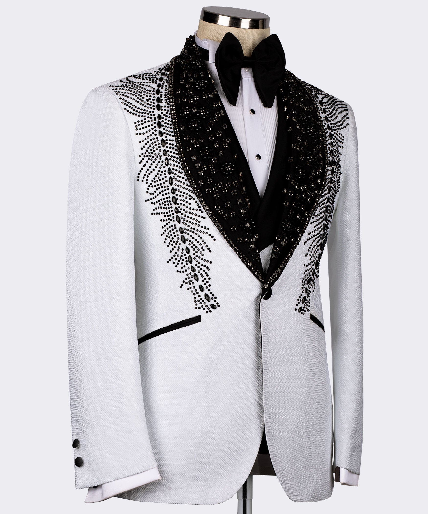 White tuxedo jacket with black lapels and feather-like stone embroidery along the sides