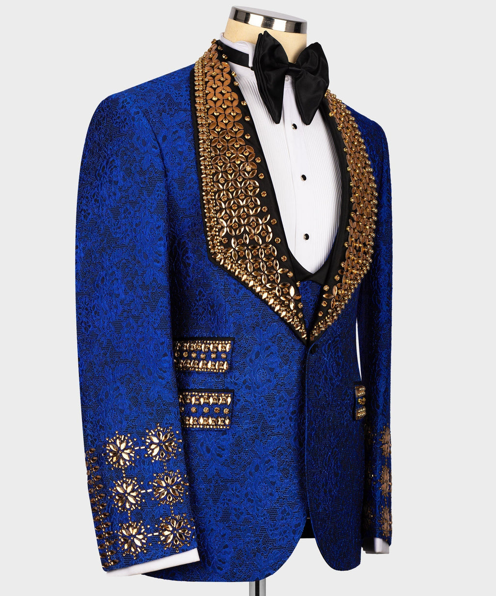 Blue tuxedo jacket with gold gem trim, jewel cuffs, black vest and bow tie