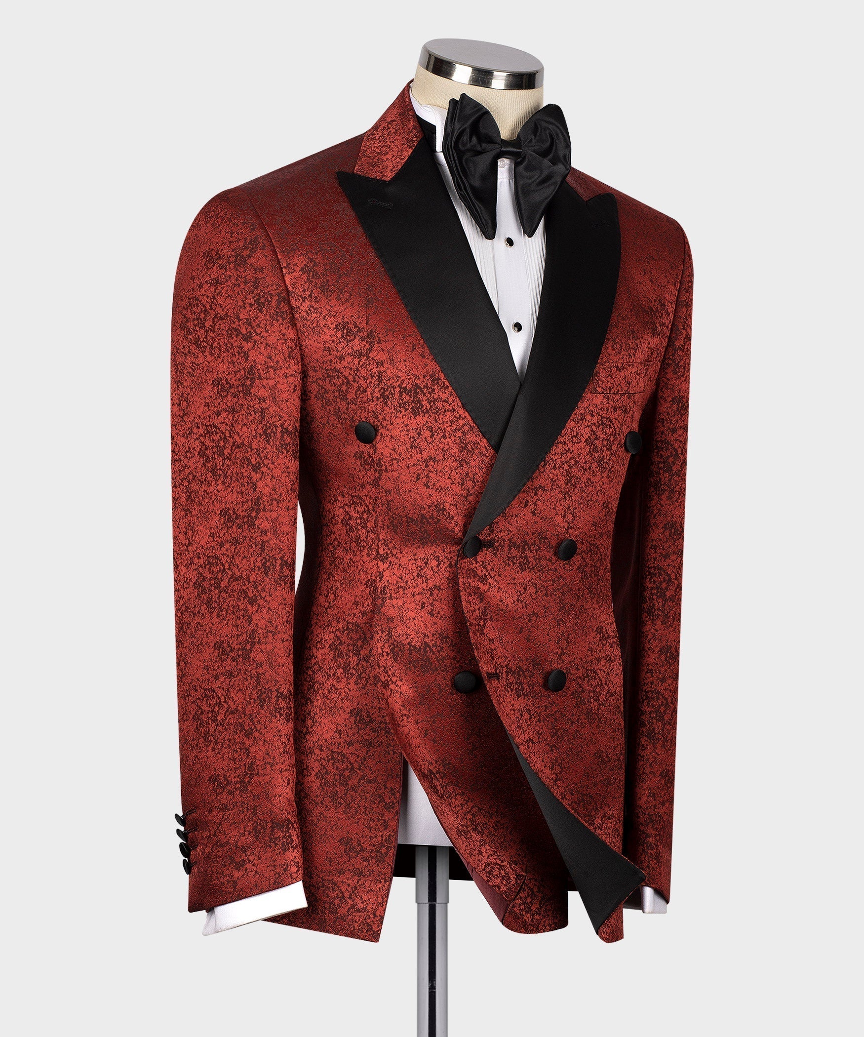 Burgundy patterned tuxedo jacket with black satin lapels, bow tie, and double-breasted buttons