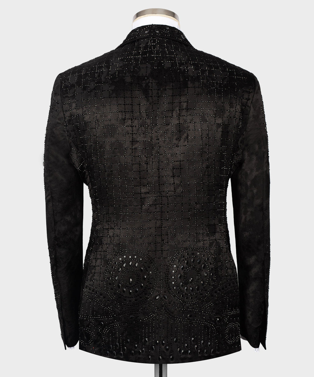 Back view black embroidered tuxedo jacket with patterned studs and curved hem