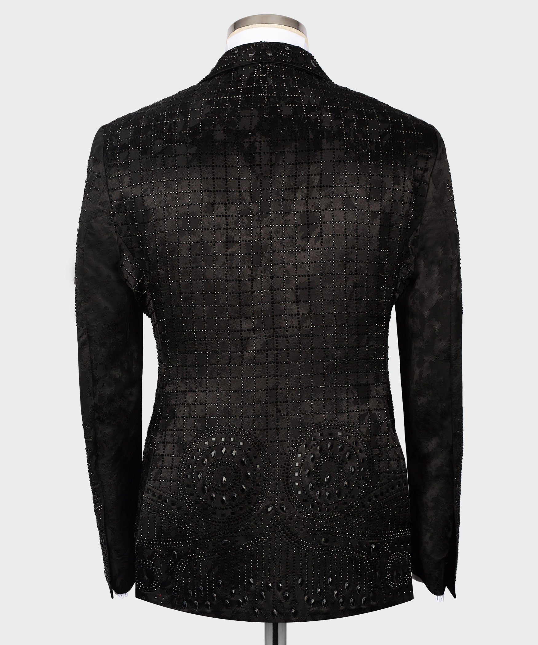Back view black embroidered tuxedo jacket with patterned studs and curved hem