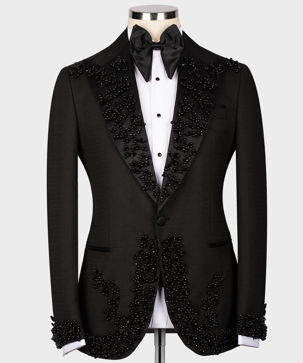 Black custom tuxedo jacket with jeweled lapels, satin bow tie, and white vest