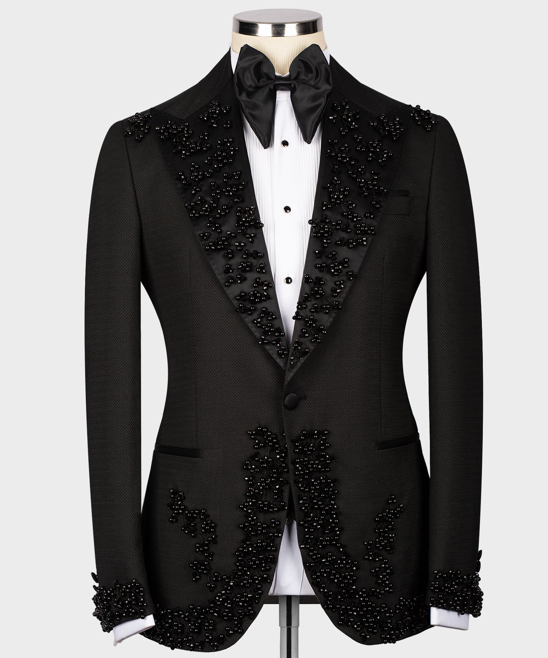 Black tuxedo jacket with jeweled lapels, satin bow tie, and matching vest
