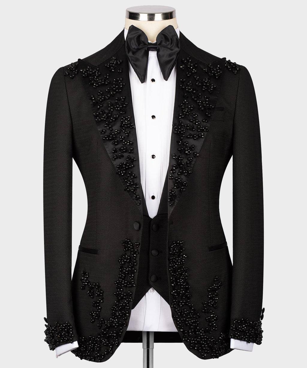Black tuxedo set with buttoned vest, jeweled detailing on lapels and cuffs
