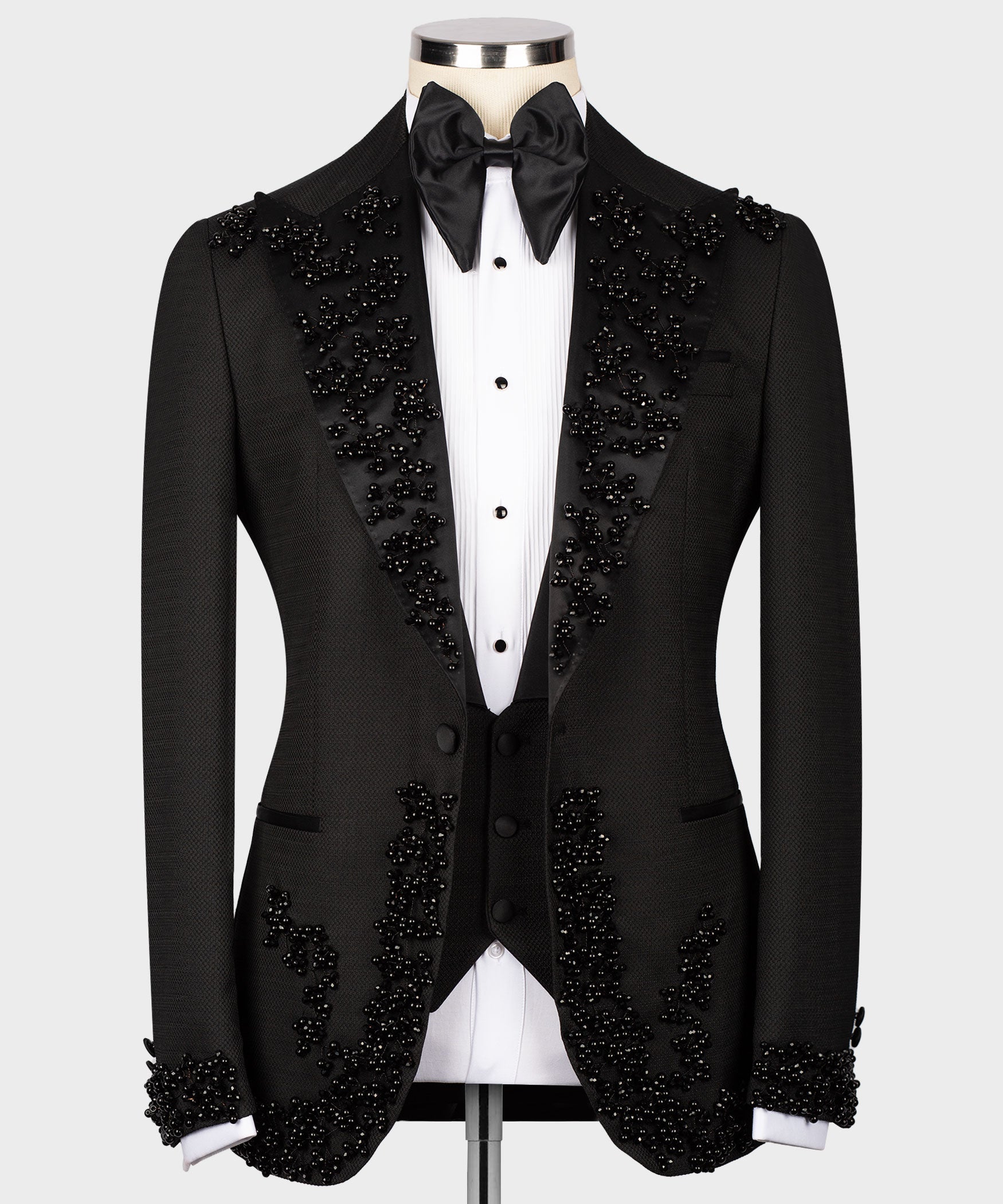 Black tuxedo set with buttoned vest, jeweled detailing on lapels and cuffs