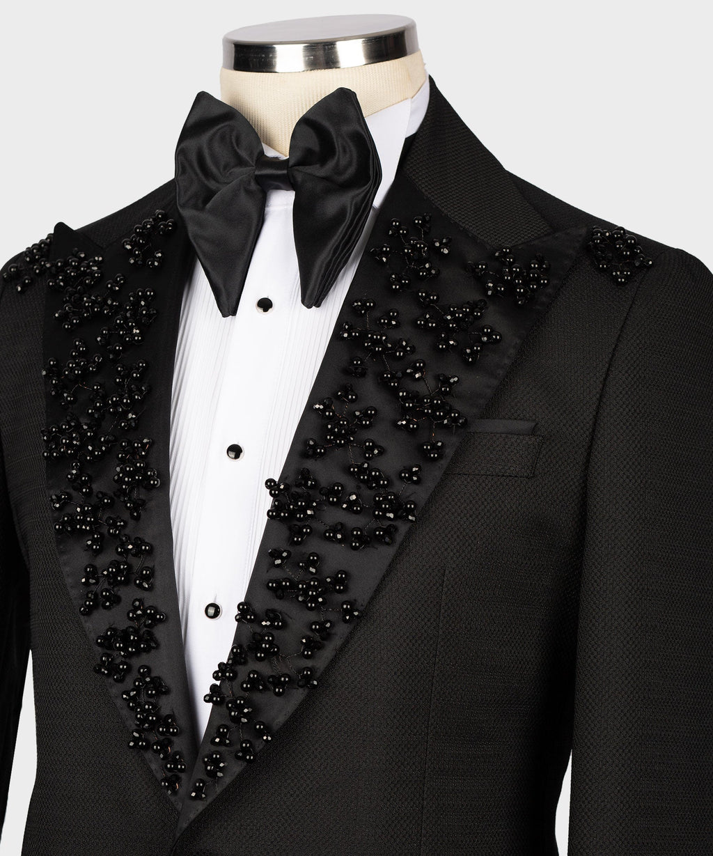 Black tuxedo lapel and satin bow tie with scattered jeweled embellishments