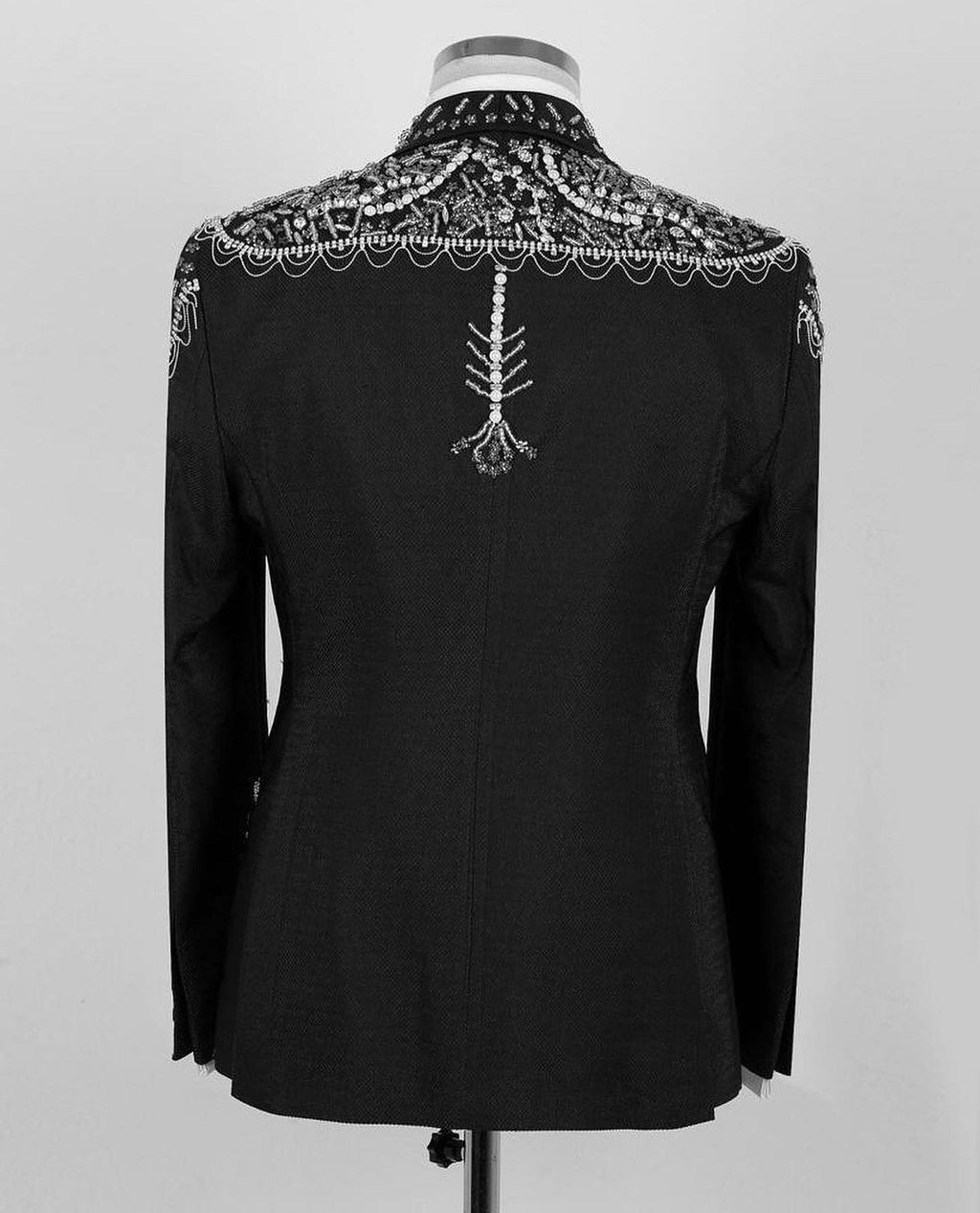 Black tuxedo jacket back with ornate silver beadwork yoke and center embellishment
