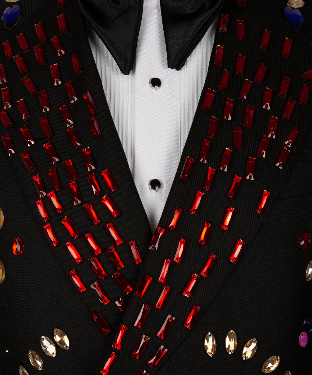 Close-up of crystal-studded tuxedo lapels and white shirt placket with black buttons