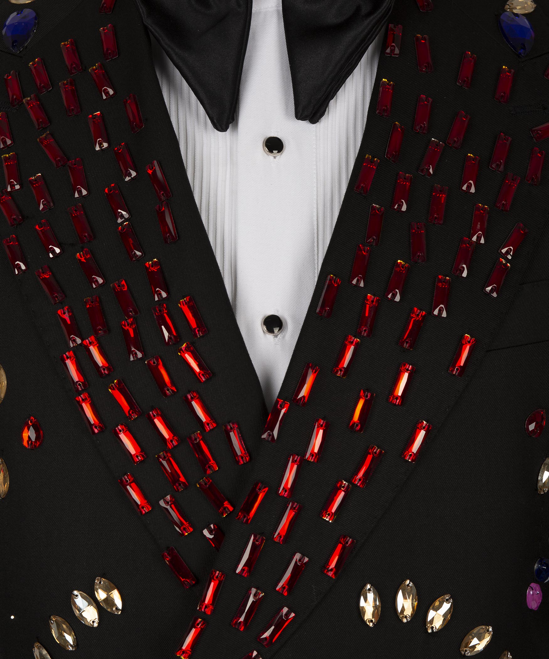 Close-up of crystal-studded tuxedo lapels and white shirt placket with black buttons