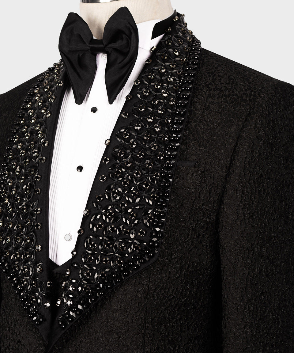 Close-up of black tuxedo bow tie and jeweled satin vest front