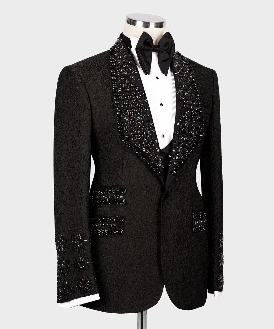 Black tuxedo jacket with embellished front panels and matching black trousers waistband