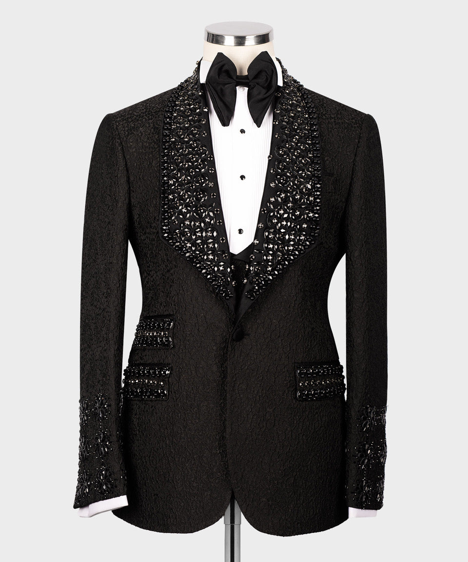 Black tuxedo jacket with jeweled sequin paneling, white shirt, and black bow tie