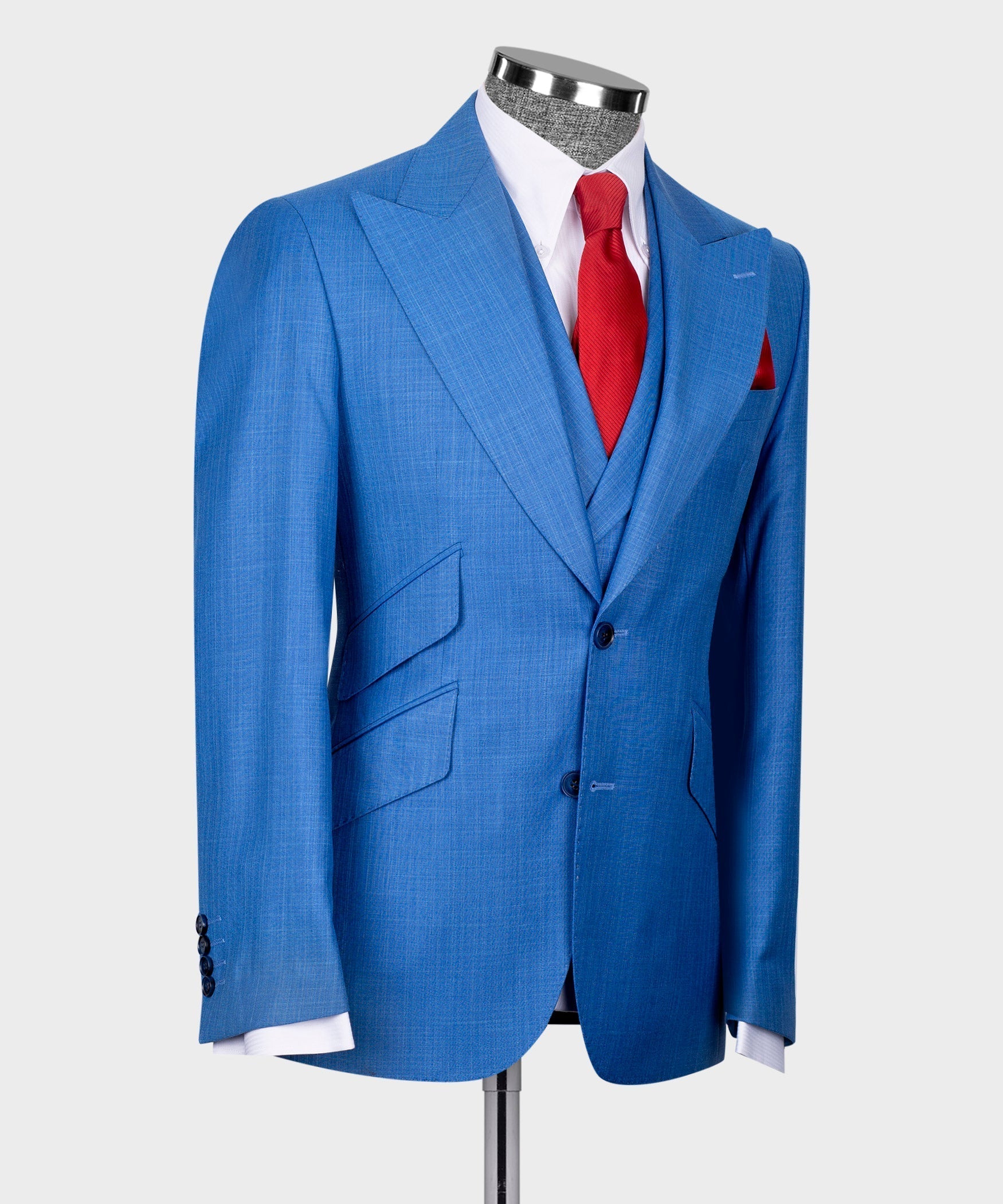 Blue suit jacket and vest with white shirt, red tie, and red pocket square