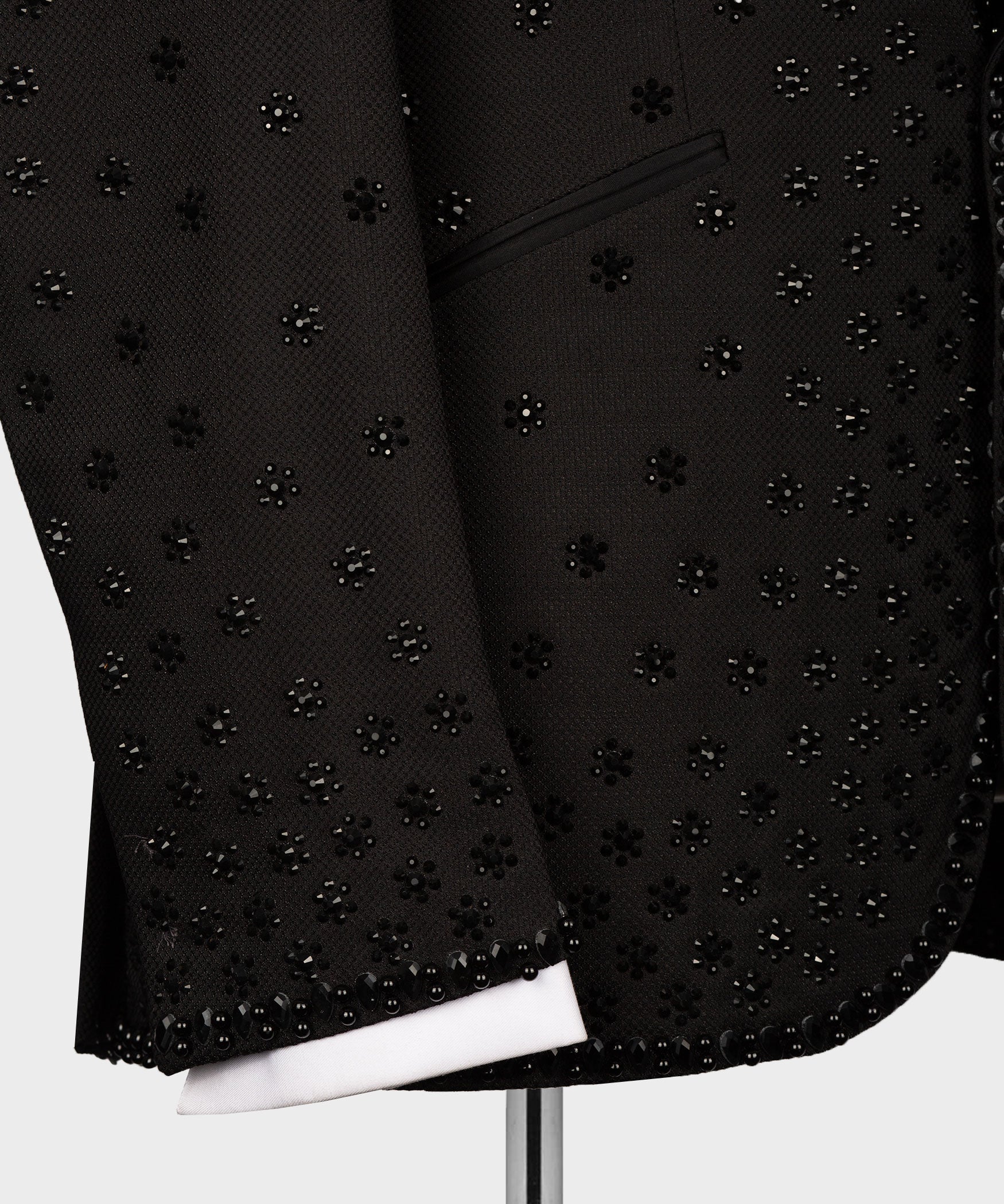 Black tuxedo jacket lower front with dense rhinestone pattern