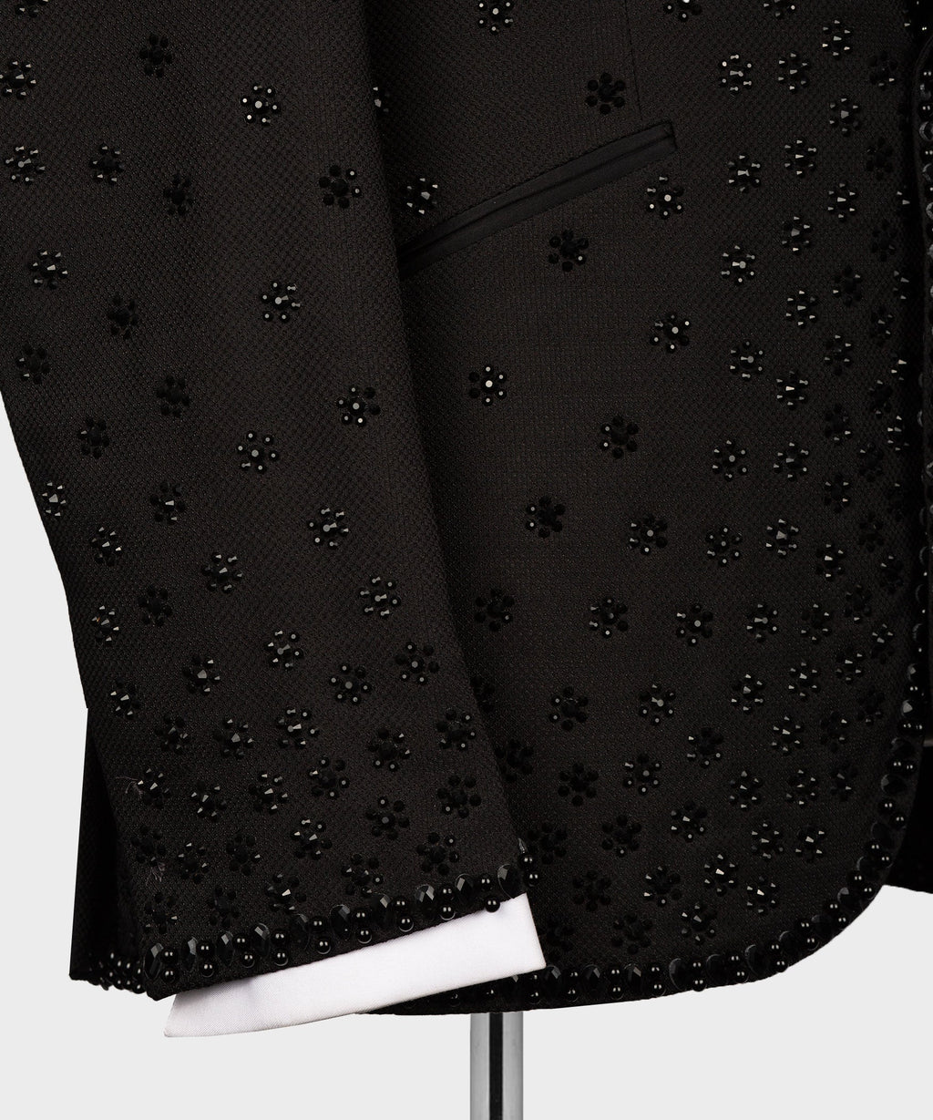 Black tuxedo jacket close-up of jeweled front panel and buttoned cuff