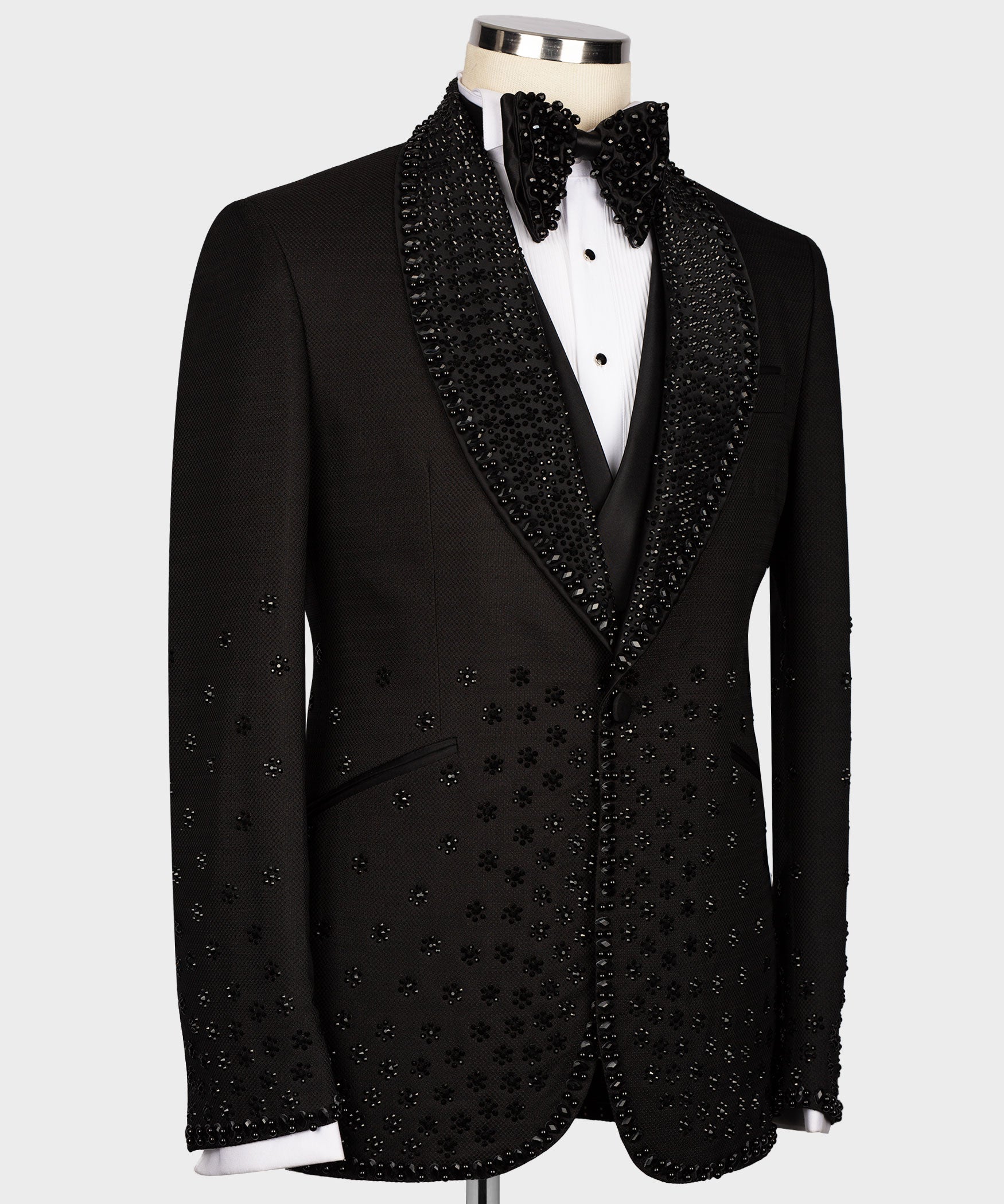 Black tuxedo jacket with sparkly gem trim on lapels and vest, bow tie