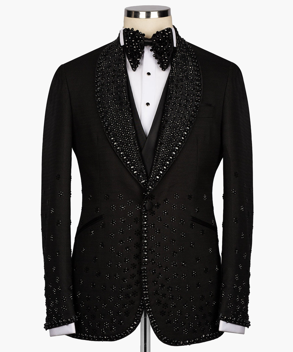 Black tuxedo jacket and vest with jeweled lapels, bow tie, and white shirt