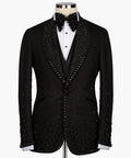Black tuxedo jacket and vest with jeweled lapels, bow tie, and white shirt