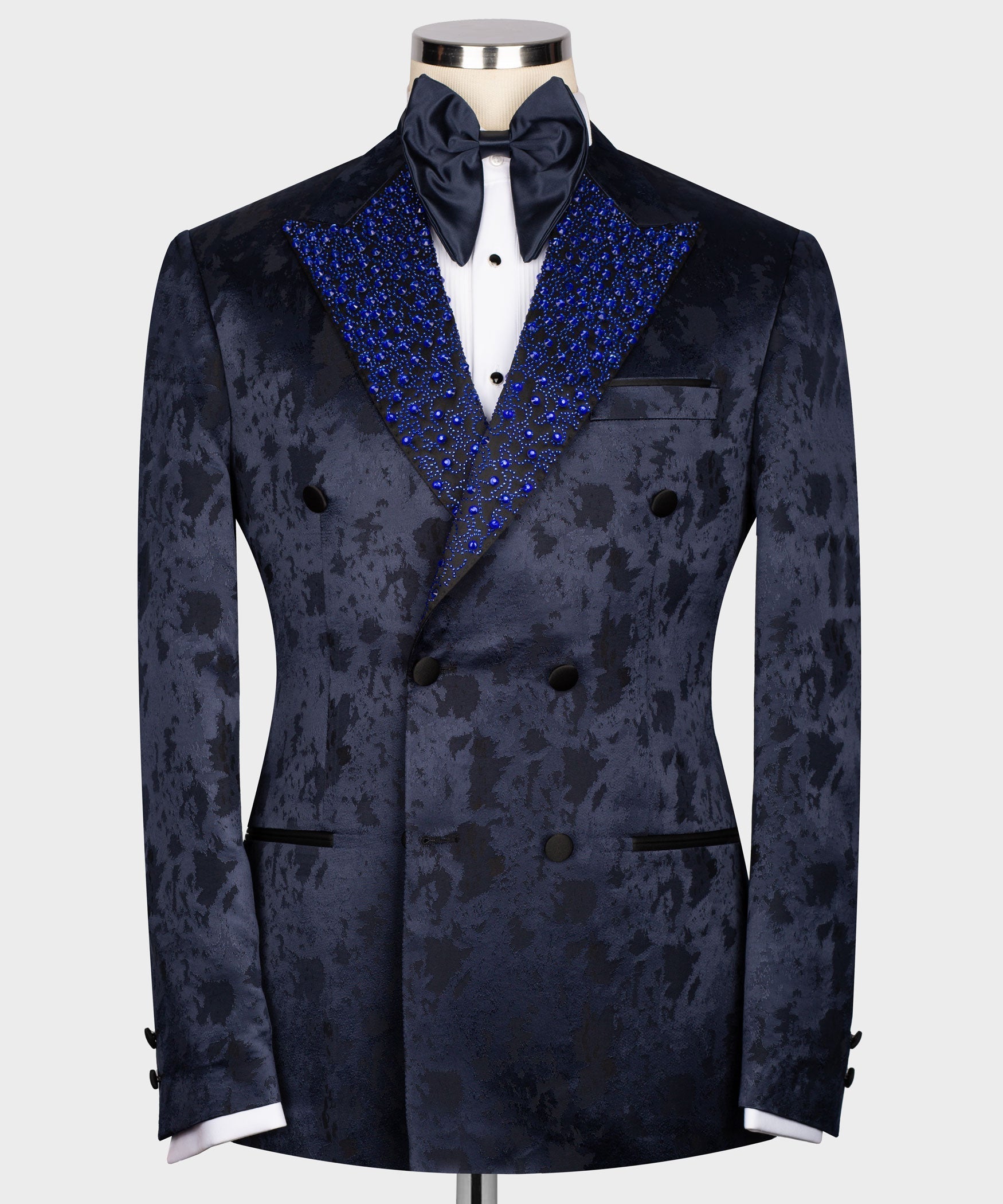 Navy formal tuxedo jacket with gemstone-embroidered blue lapels and satin bow tie