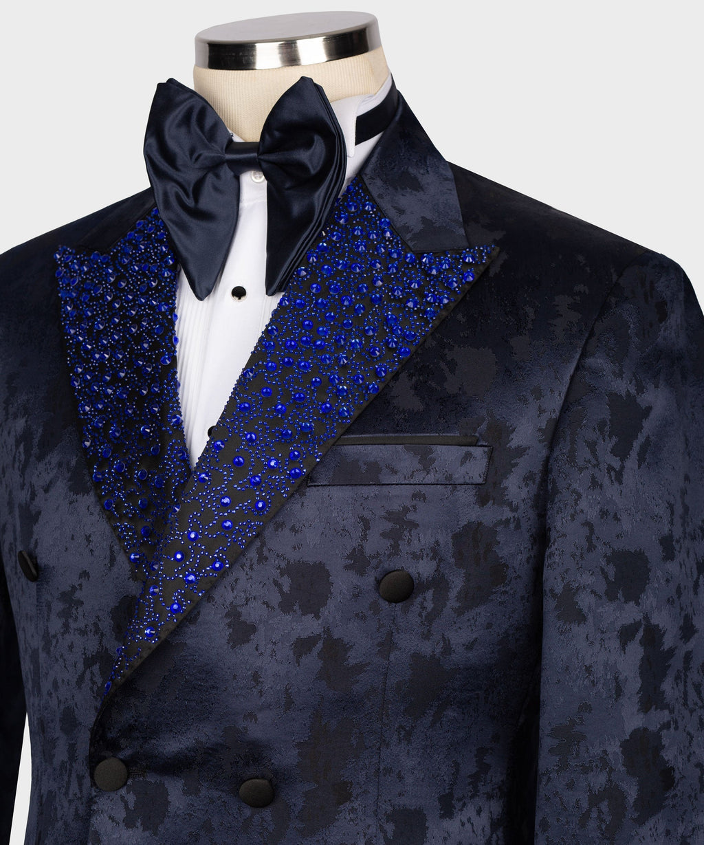 Close-up of navy tuxedo collar: white shirt, dark bow tie, blue sequin embroidery