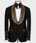 Black tuxedo jacket with gold gem-like embroidered lapels and jeweled trim at cuffs