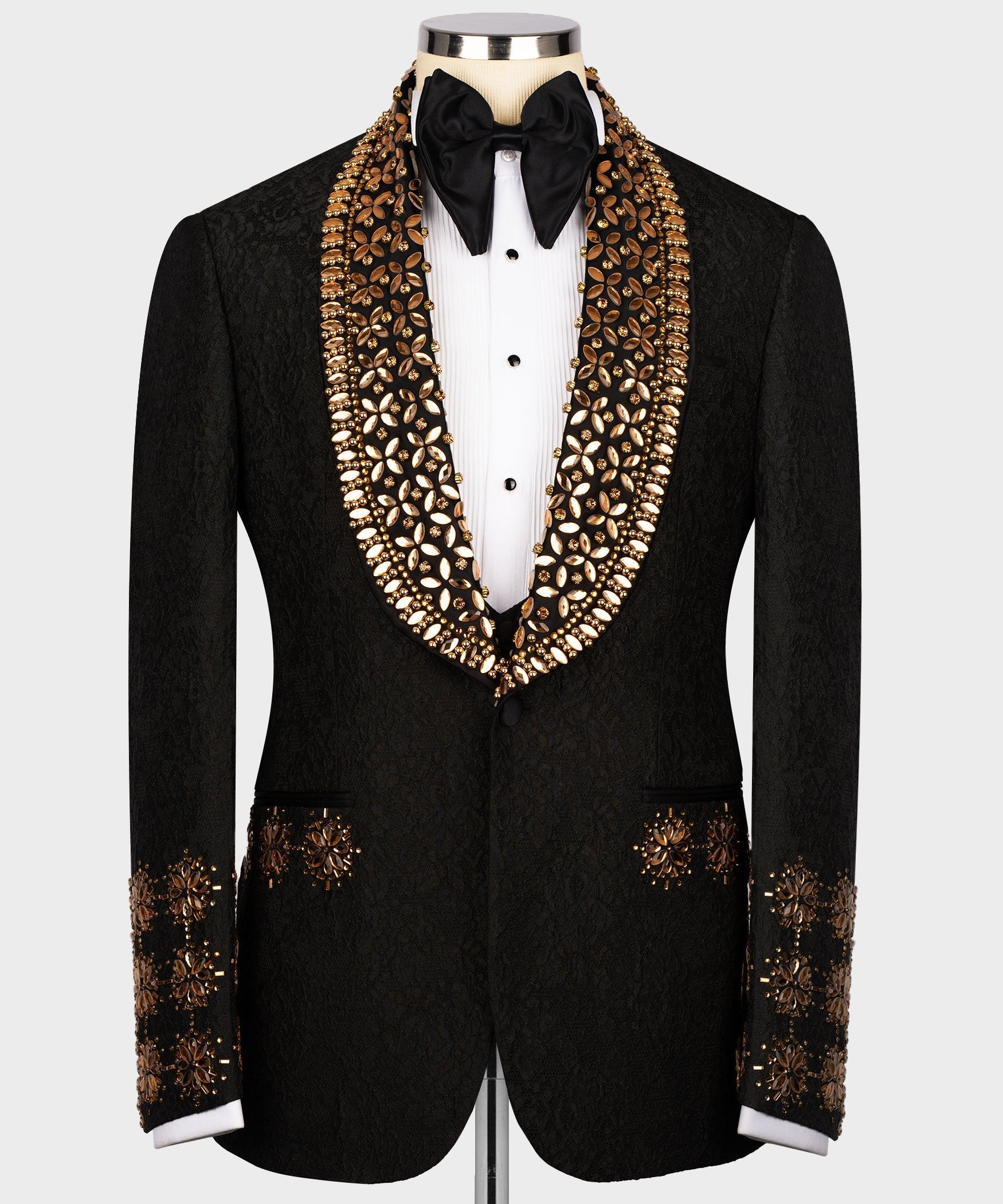 Black tuxedo jacket with gold gem-like embroidered lapels and jeweled trim at cuffs