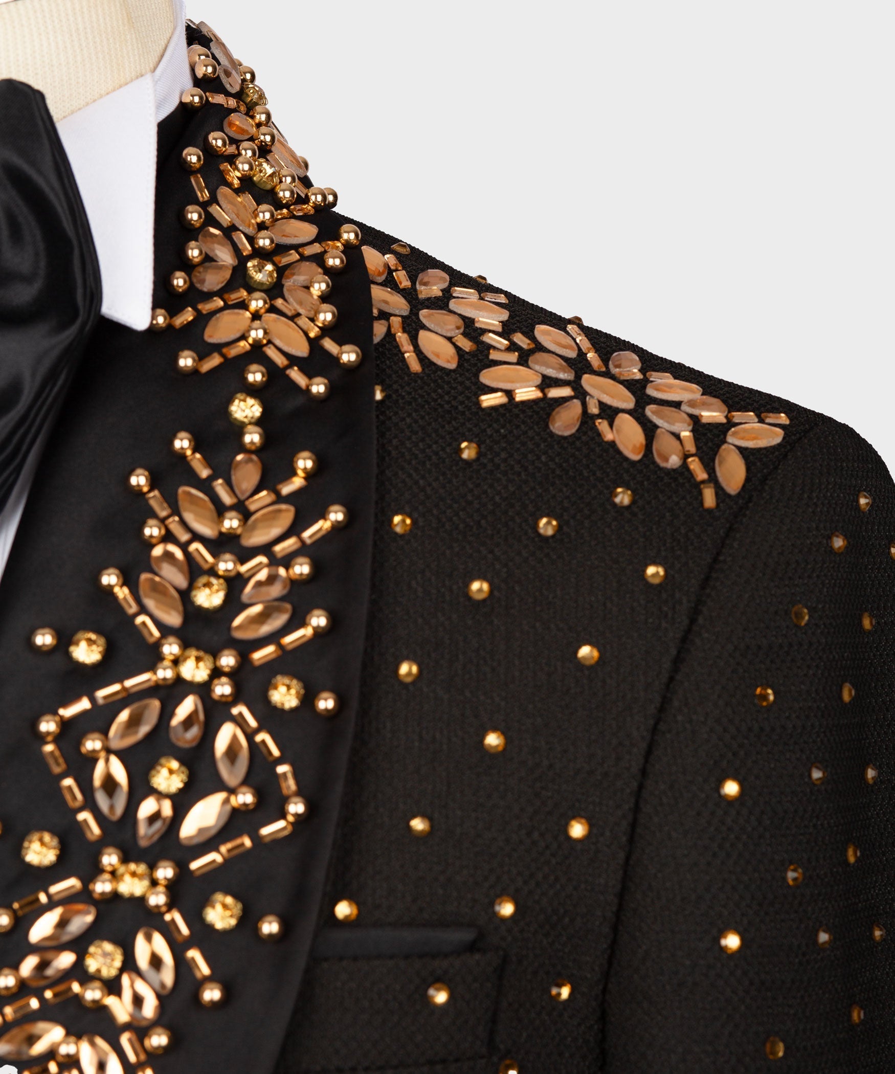 Close-up: black tuxedo jacket with gold bead and sequin floral appliqués