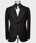 Black tuxedo jacket with embellished trim and satin bow tie at neckline