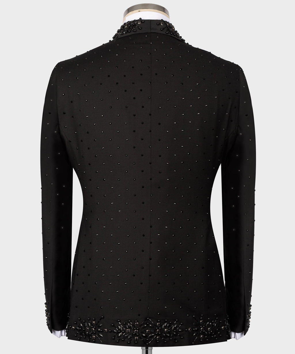 Back view of black tuxedo jacket with dotted beaded pattern and ornate hem detail