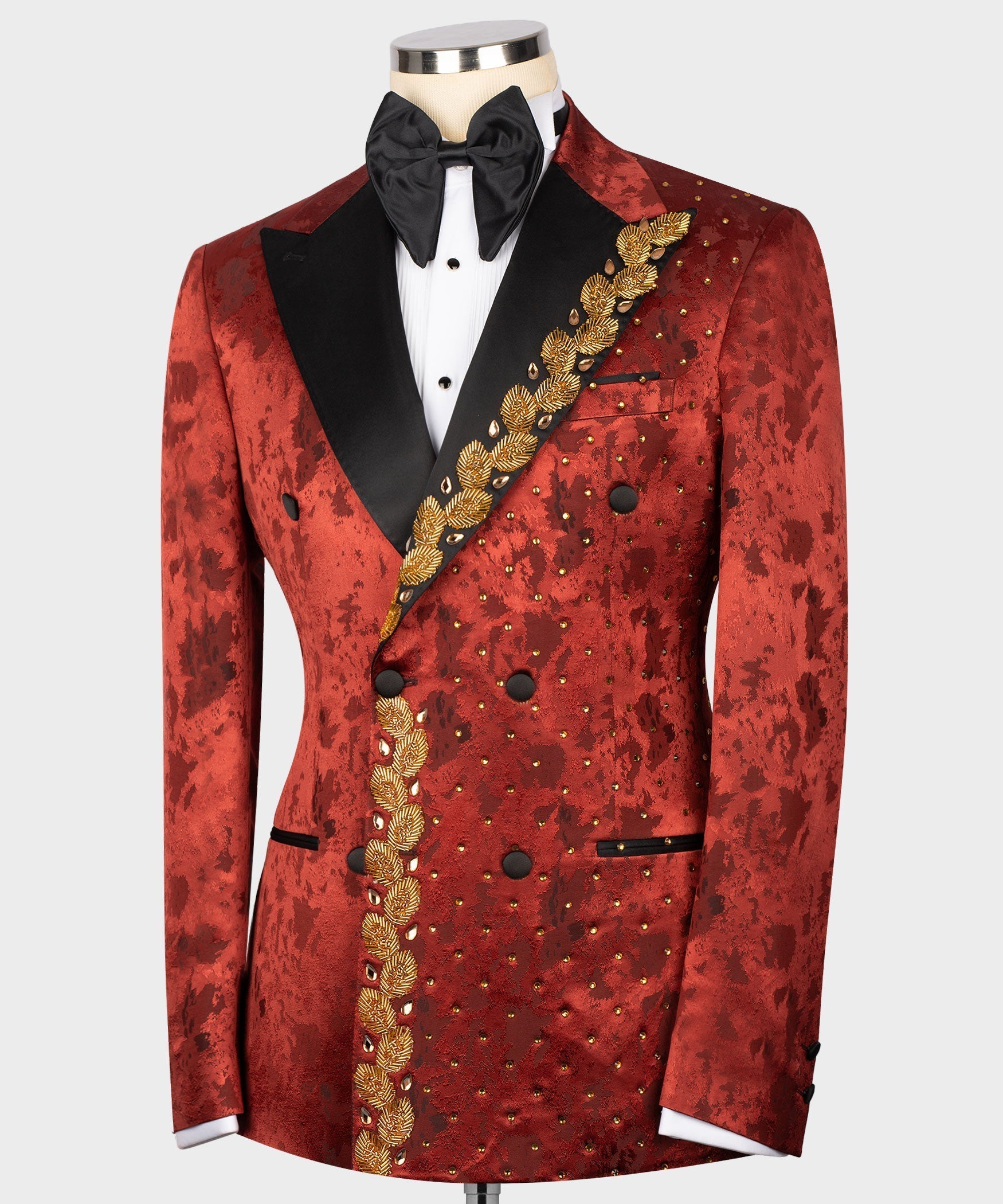 Red patterned tuxedo jacket with gold-embroidered diagonal trim and black pocket panels
