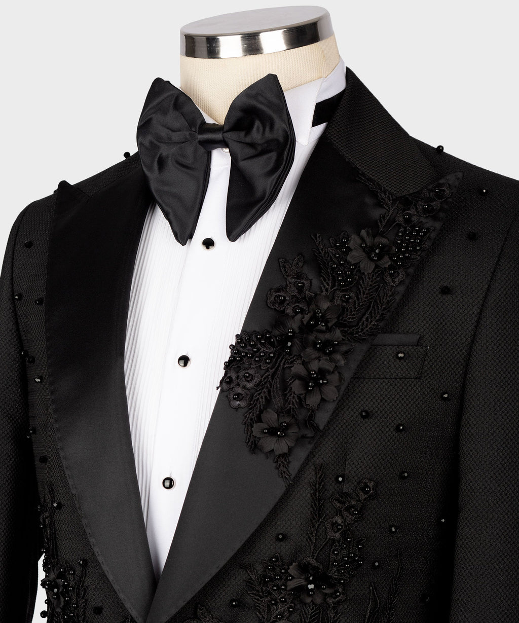 Black tuxedo lapels with floral appliqué, satin bow tie, and white shirt front