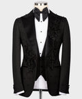 Black tuxedo jacket with floral embroidery, satin lapels, and matching bow tie