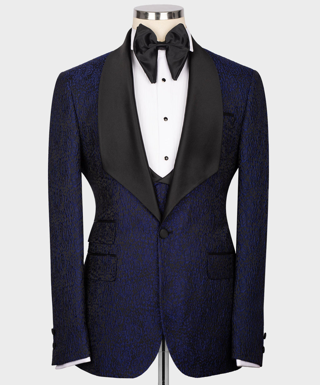 Navy embossed tuxedo jacket with black satin trim, vest buttons, and bow tie