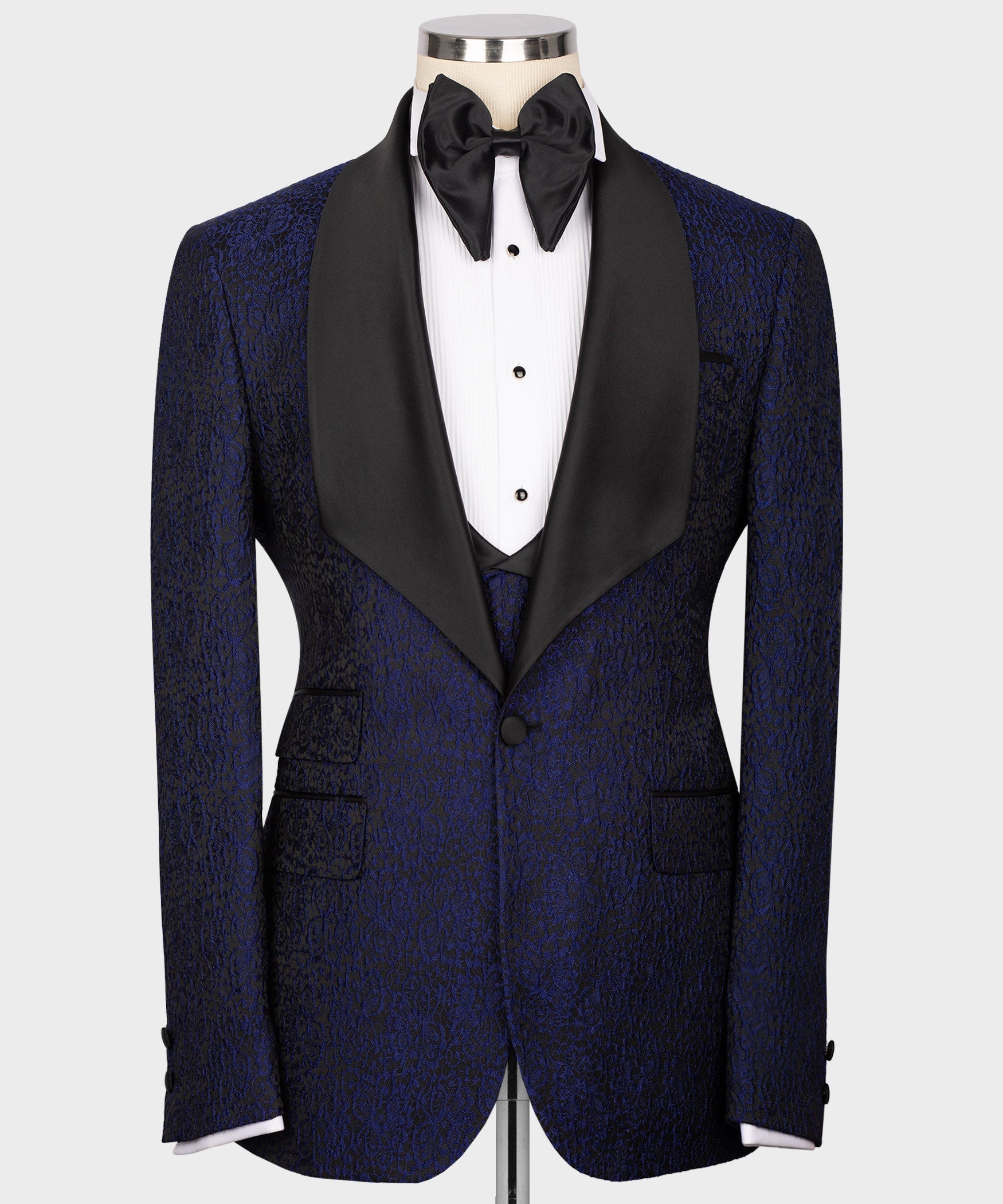Navy embossed tuxedo jacket with black satin trim, vest buttons, and bow tie