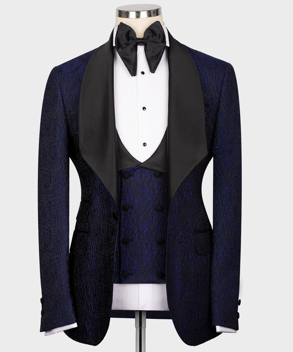 Navy tuxedo jacket with black satin lapels, vest, and bow tie in three-piece set