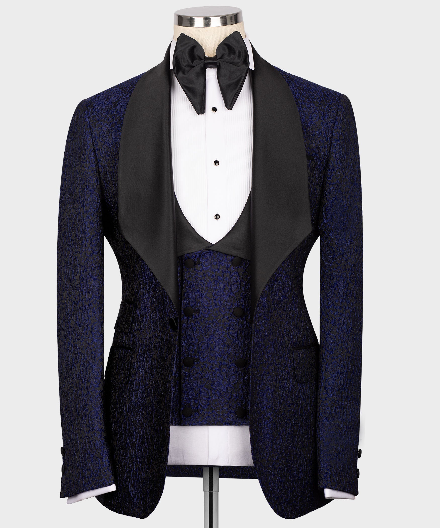 Navy tuxedo jacket with black satin lapels, vest, and bow tie in three-piece set