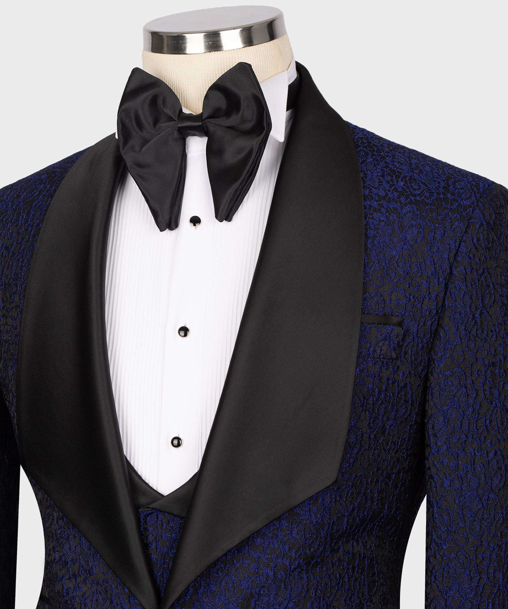 Close-up of navy tuxedo jacket with black satin shawl lapel and white shirt front