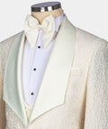 Close-up: cream embossed tuxedo jacket lapels with bow tie, vest, and shirt