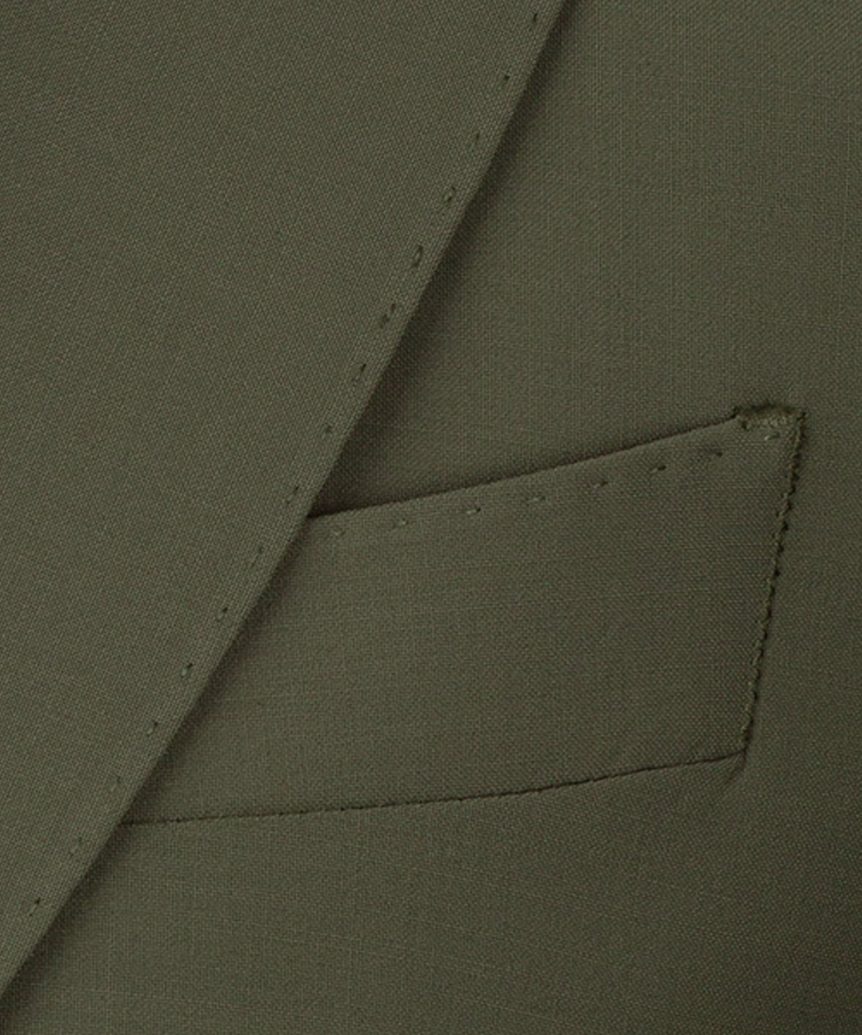 Olive waistcoat fabric close-up showing stitched pocket flap and tailored seam details