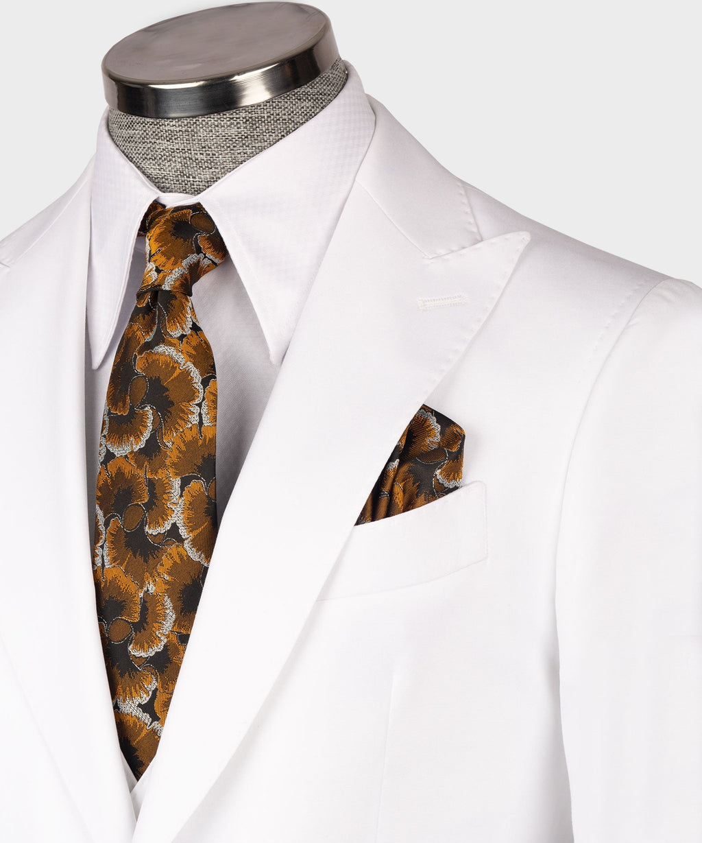 Close-up of white waistcoat lapels with patterned necktie and matching pocket square