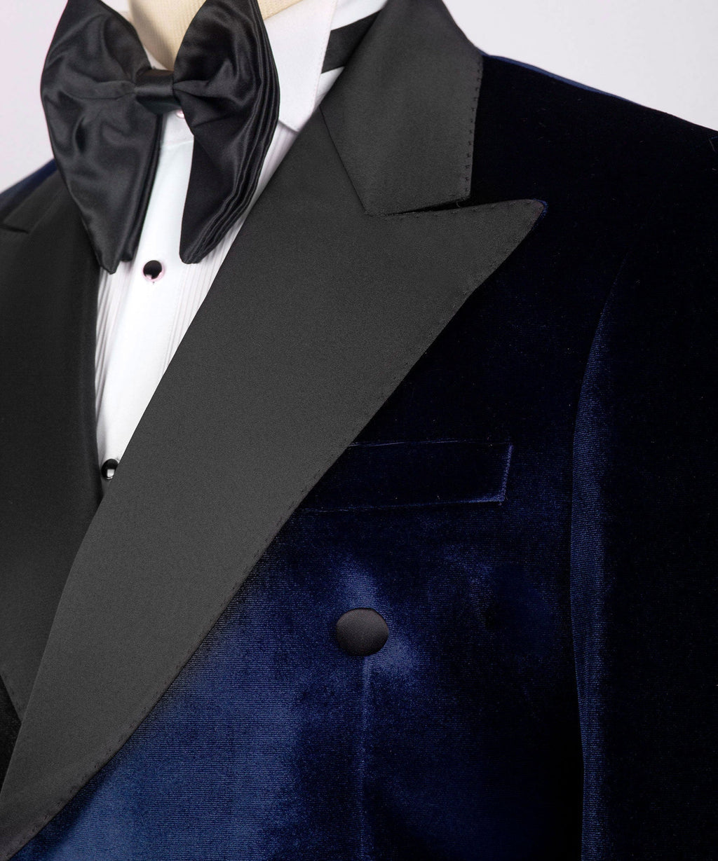 Close-up of black satin lapel, bow tie, and buttons on blue velvet tuxedo jacket