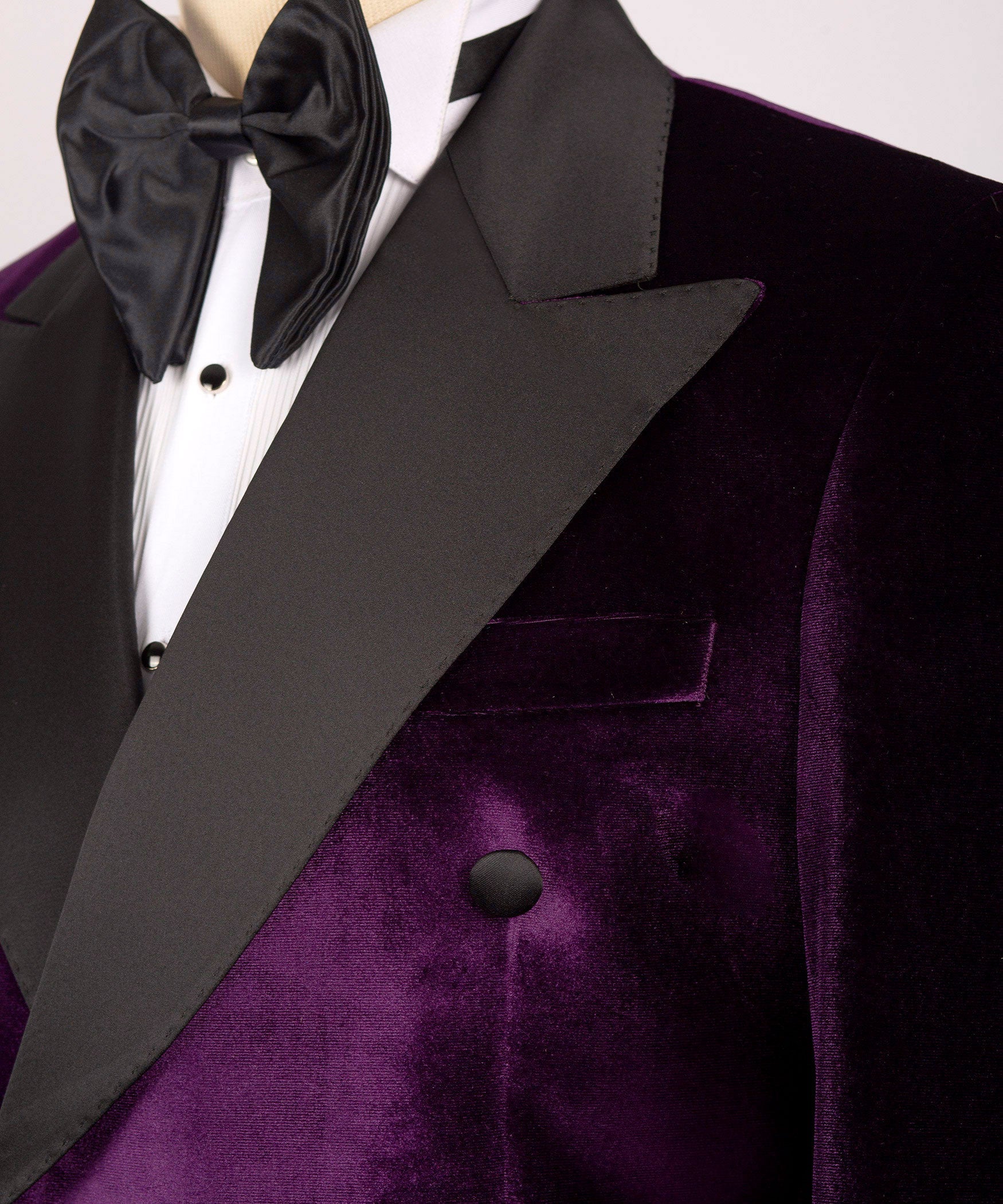 Black satin bow tie and lapel on purple velvet double-breasted tuxedo jacket
